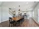 Spacious dining room with wood floors, stylish lighting, and staircase to second floor at 834 November Ln, Willow Springs, NC 27592