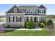 Beautiful two-story home featuring a well-manicured lawn, lush landscaping, and a welcoming front porch at 834 November Ln, Willow Springs, NC 27592