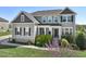 Charming two-story home with manicured lawn and flowering tree in the foreground at 834 November Ln, Willow Springs, NC 27592