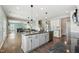 Open-concept kitchen with an island and stainless steel appliances flowing into the living area at 834 November Ln, Willow Springs, NC 27592