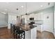 Bright kitchen features white cabinets, granite countertops, stainless steel appliances, and pendant lighting at 834 November Ln, Willow Springs, NC 27592