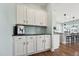 Kitchenette featuring white cabinets, black countertop, and stainless steel appliances at 834 November Ln, Willow Springs, NC 27592