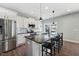 Modern kitchen with stainless steel appliances, a large island, and sleek black counter stools at 834 November Ln, Willow Springs, NC 27592