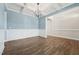 Bright living space featuring new hardwood floors, white trim, and a modern light fixture at 834 November Ln, Willow Springs, NC 27592