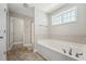 The main bathroom features a soaking tub with tile surround and a window offering natural light at 834 November Ln, Willow Springs, NC 27592