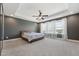 The main bedroom has carpet, a tray ceiling with recessed lights, and lots of natural light from the windows at 834 November Ln, Willow Springs, NC 27592