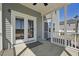Covered porch with double doors, offering a shaded outdoor living space at 834 November Ln, Willow Springs, NC 27592