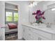 Bright bathroom boasts dual vanity, modern lighting, and a glimpse of the bedroom at 88 Baldwin St, Lillington, NC 27546
