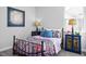 Stylish bedroom featuring blue pillows, patterned bedding, and decorative bedside tables with lamps at 88 Baldwin St, Lillington, NC 27546
