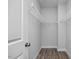 Walk-in closet featuring wire shelving and wood-look flooring, creating a functional storage space at 88 Baldwin St, Lillington, NC 27546