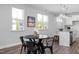 Bright kitchen and dining area with granite countertops, stainless steel appliances, and luxury vinyl flooring at 88 Baldwin St, Lillington, NC 27546