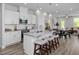 Open-concept kitchen featuring a center island with seating, modern appliances, and views of the dining area at 88 Baldwin St, Lillington, NC 27546