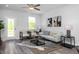 Open concept living room with natural light, luxury vinyl flooring, and contemporary furniture at 88 Baldwin St, Lillington, NC 27546