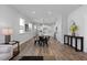 Open concept living and dining area with modern lighting and hardwood floors at 88 Baldwin St, Lillington, NC 27546