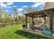 Beautiful backyard with a gazebo, lush lawn, and mature trees, perfect for outdoor enjoyment at 1000 Milkweed Ct, Zebulon, NC 27597