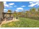 A backyard with a covered grill, nice lawn, and small wooded area at 1000 Milkweed Ct, Zebulon, NC 27597