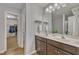 Bright bathroom with double sinks, a large mirror, and a walk-in closet for ample storage at 1000 Milkweed Ct, Zebulon, NC 27597