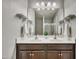 Bathroom featuring double sinks, a large mirror, and a glass shower creating a spa-like atmosphere at 1000 Milkweed Ct, Zebulon, NC 27597