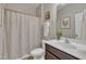 Clean bathroom with a toilet, sink, vanity, mirror, and a shower with a curtain at 1000 Milkweed Ct, Zebulon, NC 27597