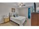 Bedroom with a metal bed frame, ceiling fan, and bright blue curtains for a lovely ambiance at 1000 Milkweed Ct, Zebulon, NC 27597