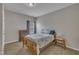 Cozy bedroom featuring a wooden bed frame, side table, and a window with natural light at 1000 Milkweed Ct, Zebulon, NC 27597