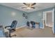 Home office with blue walls, ceiling fan, large desk, office chairs and natural light at 1000 Milkweed Ct, Zebulon, NC 27597