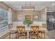 A bright dining room with hardwood floors, a large window, and decorative light fixture at 1000 Milkweed Ct, Zebulon, NC 27597