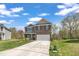 Beautiful two-story home boasting a manicured lawn, large driveway, and brick and vinyl siding at 1000 Milkweed Ct, Zebulon, NC 27597