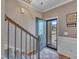 Inviting foyer with decorative rug, staircase, and open doorway to the outdoors at 1000 Milkweed Ct, Zebulon, NC 27597