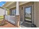 Inviting front porch with brick columns, white railings, and a stylish front door at 1000 Milkweed Ct, Zebulon, NC 27597