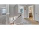 Upstairs hallway with neutral carpet, a staircase, and doors leading to other rooms at 1000 Milkweed Ct, Zebulon, NC 27597