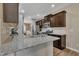 Stylish kitchen featuring granite countertops, stainless steel appliances, and dark wood cabinets at 1000 Milkweed Ct, Zebulon, NC 27597