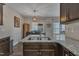 A granite countertop island highlights this kitchen with stainless steel sink at 1000 Milkweed Ct, Zebulon, NC 27597