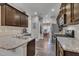 Modern kitchen with granite counters, stainless steel appliances, and dark cabinets at 1000 Milkweed Ct, Zebulon, NC 27597