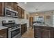 Bright kitchen features stainless steel appliances, granite countertops, and dark wood cabinetry at 1000 Milkweed Ct, Zebulon, NC 27597