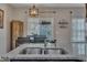 A granite countertop island highlights this kitchen with stainless steel sink at 1000 Milkweed Ct, Zebulon, NC 27597