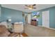 Comfortable living room with blue walls, ceiling fan, and entertainment center at 1000 Milkweed Ct, Zebulon, NC 27597