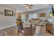 Cozy living room with a ceiling fan, two armchairs, a couch, and an adjacent dining area at 1000 Milkweed Ct, Zebulon, NC 27597
