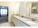 Bathroom featuring double sinks, granite counters, and doorway to the bedroom at 103 Thornwhistle Pl, Garner, NC 27529