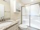 Bathroom featuring granite countertops, tiled floors and walk-in shower at 103 Thornwhistle Pl, Garner, NC 27529