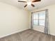 Bedroom with ceiling fan and window features neutral decor and carpeted flooring at 103 Thornwhistle Pl, Garner, NC 27529