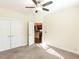 Bedroom features carpet, ceiling fan, and an open doorway leading to the kitchen at 103 Thornwhistle Pl, Garner, NC 27529