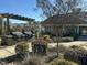 Outdoor community area with built-in grills and plenty of seating amid lush landscaping at 103 Thornwhistle Pl, Garner, NC 27529