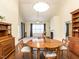Cozy dining area with hardwood floors, a round wooden table, and natural light at 103 Thornwhistle Pl, Garner, NC 27529