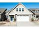 Charming home with a white garage door, blue front door, and well-maintained landscaping at 103 Thornwhistle Pl, Garner, NC 27529