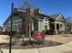 Charming building featuring a sign, 'The Lodge', set against a blue sky and well-maintained landscaping at 103 Thornwhistle Pl, Garner, NC 27529