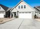 Charming home with a white garage door and well-maintained landscaping at 103 Thornwhistle Pl, Garner, NC 27529