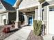 Welcoming entryway with a blue front door, stone accents, and manicured bushes at 103 Thornwhistle Pl, Garner, NC 27529