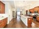 Spacious kitchen with hardwood floors, stainless steel appliances, and granite countertops at 103 Thornwhistle Pl, Garner, NC 27529