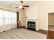 Inviting living room featuring a fireplace, ceiling fan, and large window at 103 Thornwhistle Pl, Garner, NC 27529